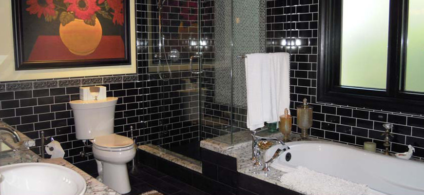 Large tuscan black tile and porcelain tile bathroom photo in Vancouver with raised-panel cabinets, white cabinets, granite countertops and beige walls