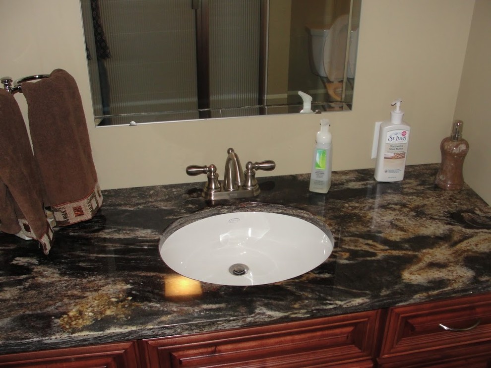 Example of a mid-sized 3/4 medium tone wood floor bathroom design in Other with an undermount sink, medium tone wood cabinets, marble countertops and beige walls