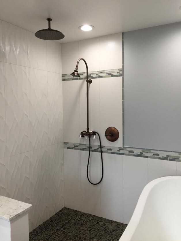 Medium sized contemporary ensuite wet room bathroom in Hawaii with a claw-foot bath, green tiles, white tiles, porcelain tiles, grey walls, pebble tile flooring, multi-coloured floors and an open shower.