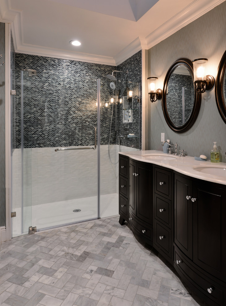 Inspiration for a mid-sized modern master gray tile and mosaic tile marble floor walk-in shower remodel in New York with furniture-like cabinets, black cabinets, a one-piece toilet, gray walls, an undermount sink and quartz countertops
