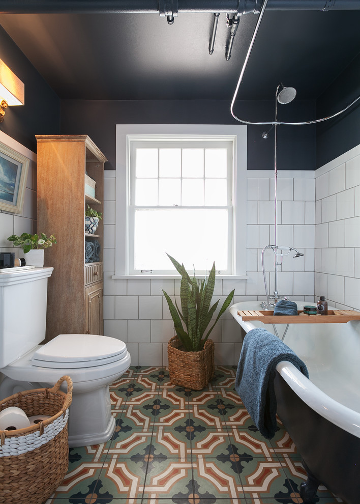 Design ideas for a classic family bathroom in Seattle with a claw-foot bath, a shower/bath combination, a one-piece toilet, white tiles, ceramic tiles, blue walls and mosaic tile flooring.