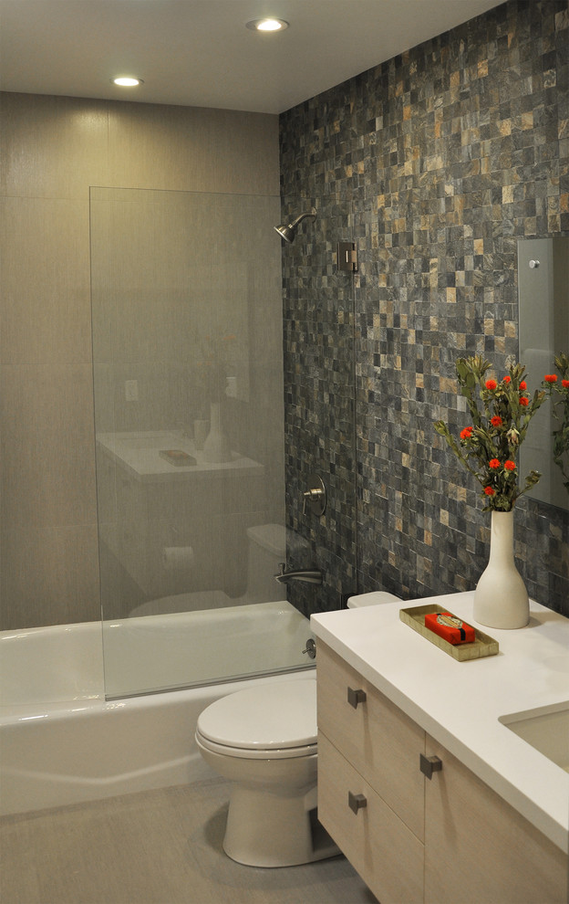 Example of a mid-sized trendy multicolored tile and mosaic tile porcelain tile bathroom design in San Francisco with an undermount sink, flat-panel cabinets, light wood cabinets, quartz countertops, a one-piece toilet and multicolored walls