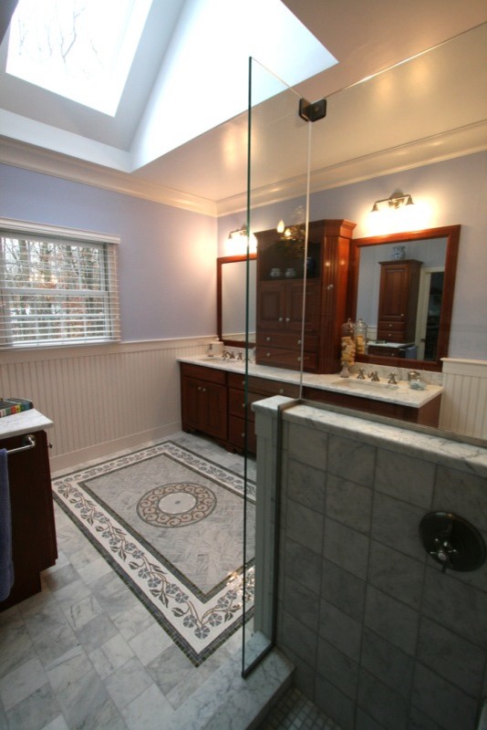 Design ideas for a large traditional ensuite bathroom in Bridgeport with a pedestal sink, recessed-panel cabinets, dark wood cabinets, marble worktops, a built-in bath, a corner shower, grey tiles, stone tiles, blue walls and travertine flooring.