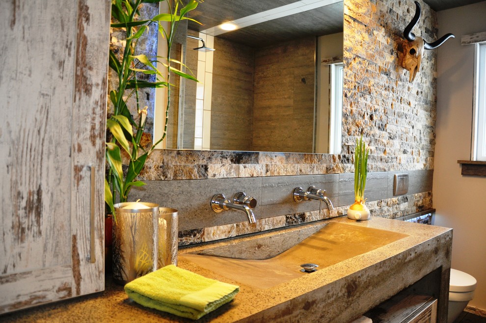 Photo of a large rustic ensuite bathroom in Toronto with an integrated sink, shaker cabinets, concrete worktops, a wall mounted toilet and beige walls.