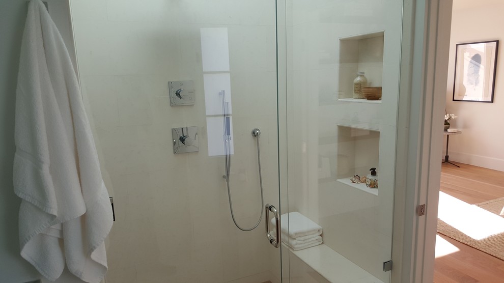 Idée de décoration pour une douche en alcôve design en bois brun de taille moyenne avec un placard à porte plane, un carrelage blanc, un lavabo encastré, un plan de toilette en marbre, un sol blanc et une cabine de douche à porte battante.