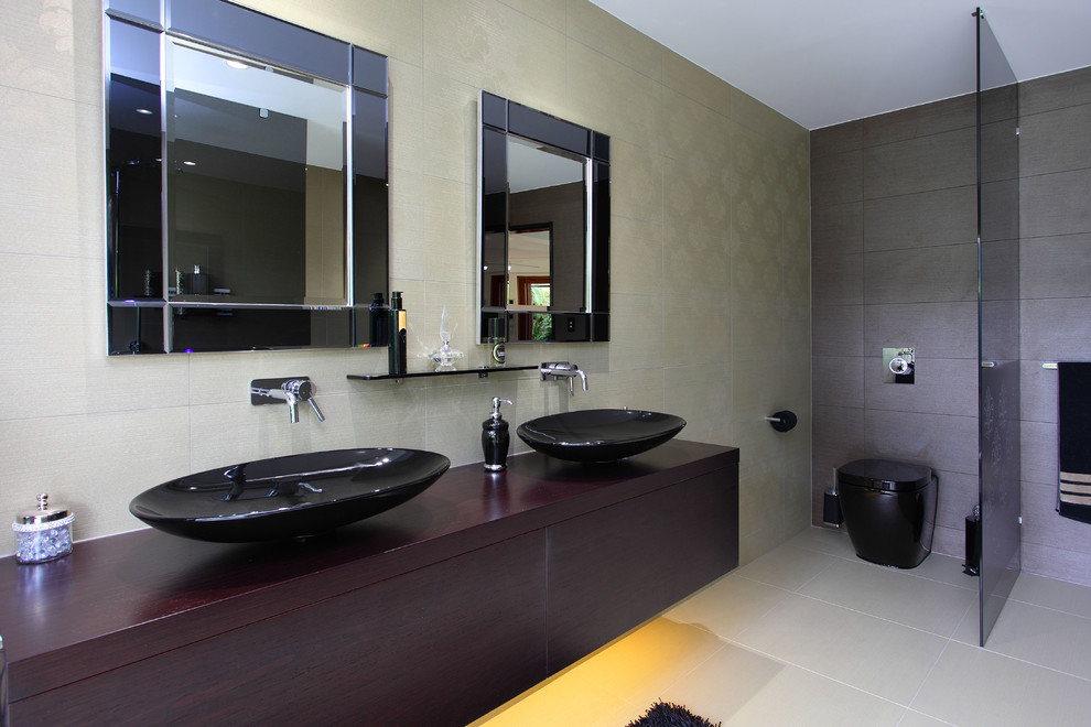 Bathroom - large contemporary master multicolored tile bathroom idea in Brisbane with furniture-like cabinets, black cabinets, a one-piece toilet, a vessel sink, wood countertops and black countertops