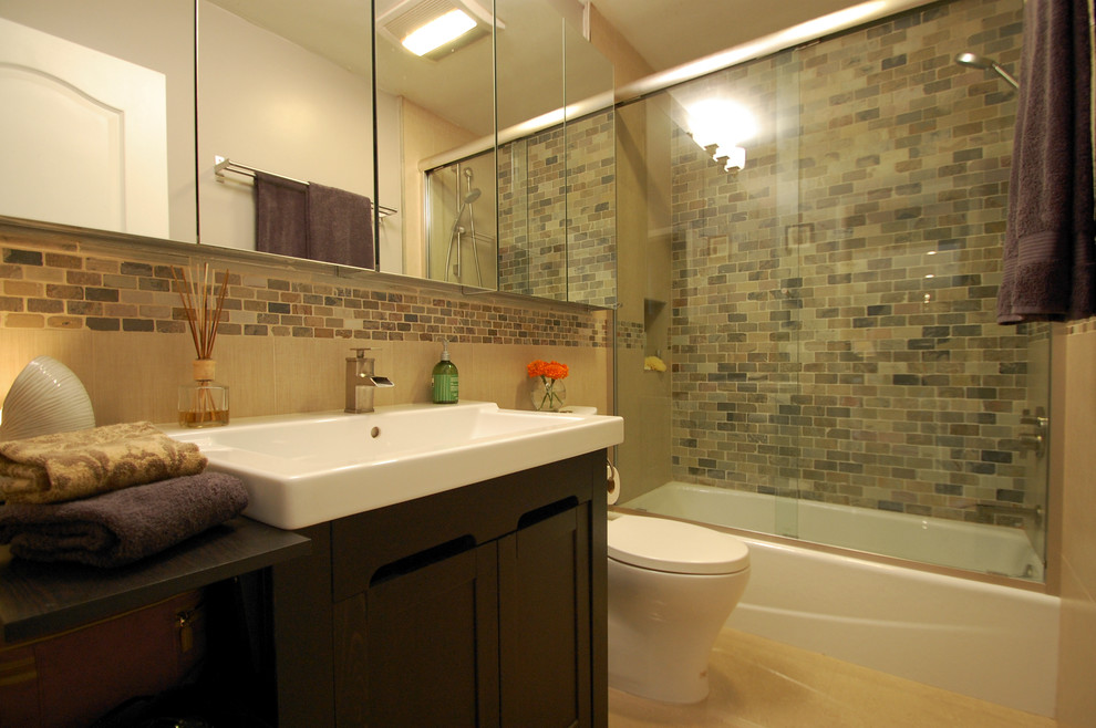 Example of a small trendy master beige tile and stone tile porcelain tile bathroom design in Los Angeles with a trough sink, shaker cabinets, dark wood cabinets, a two-piece toilet and gray walls
