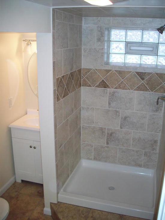 Inspiration for a small timeless 3/4 beige tile and stone tile linoleum floor corner shower remodel in New York with a pedestal sink, flat-panel cabinets, white cabinets and white walls