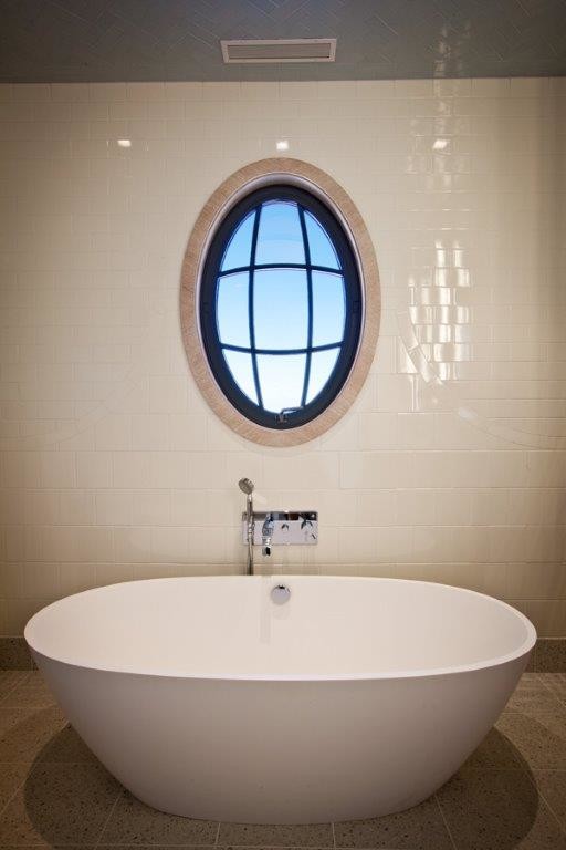 На фото: ванная комната в классическом стиле с отдельно стоящей ванной и бежевой плиткой