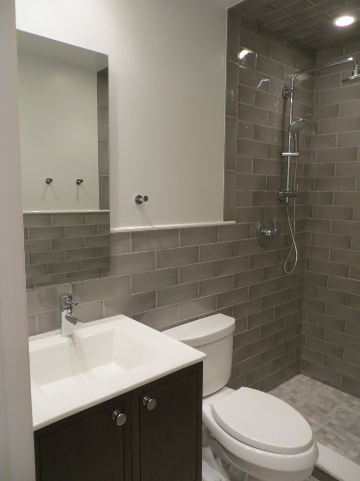 Photo of a small contemporary bathroom in Chicago with white cabinets, an alcove shower, a two-piece toilet, ceramic tiles, a submerged sink, granite worktops, a hinged door, freestanding cabinets, white tiles and white worktops.