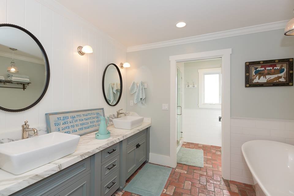 Пример оригинального дизайна: большая главная ванная комната в стиле неоклассика (современная классика) с фасадами с декоративным кантом, серыми фасадами, отдельно стоящей ванной, душем в нише, унитазом-моноблоком, белой плиткой, керамической плиткой, серыми стенами, кирпичным полом, настольной раковиной, мраморной столешницей, красным полом, душем с распашными дверями и серой столешницей