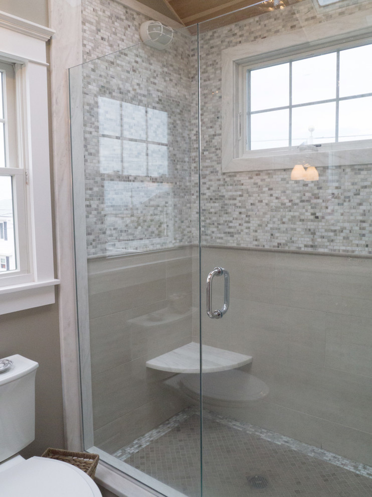 Alcove shower - small coastal master gray tile and ceramic tile ceramic tile alcove shower idea in Providence with recessed-panel cabinets, gray cabinets, a one-piece toilet, gray walls, an integrated sink and granite countertops