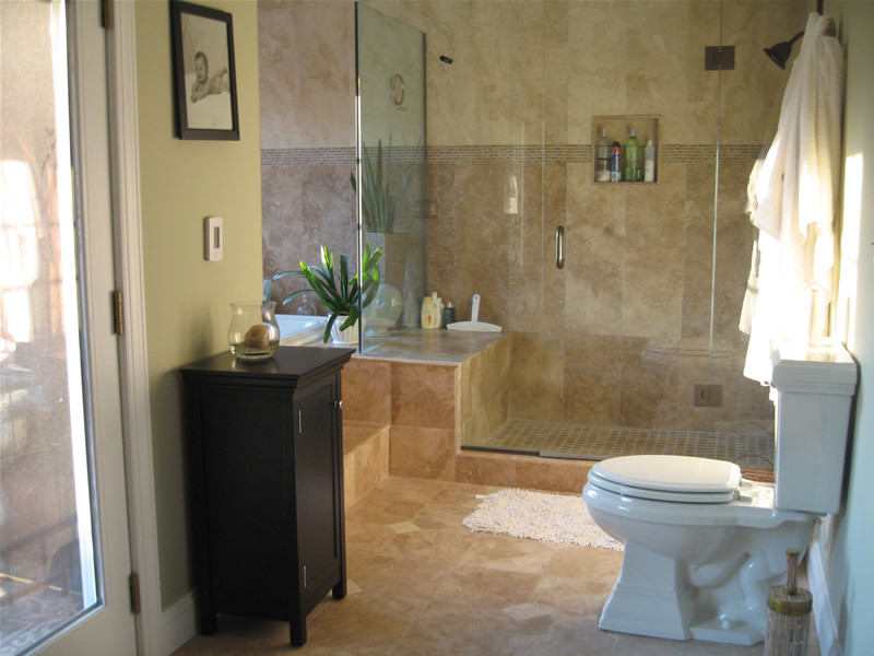 Design ideas for a medium sized traditional ensuite bathroom in Los Angeles with flat-panel cabinets, dark wood cabinets, beige tiles, ceramic tiles, a corner shower, a one-piece toilet, beige walls, ceramic flooring, a built-in sink and marble worktops.