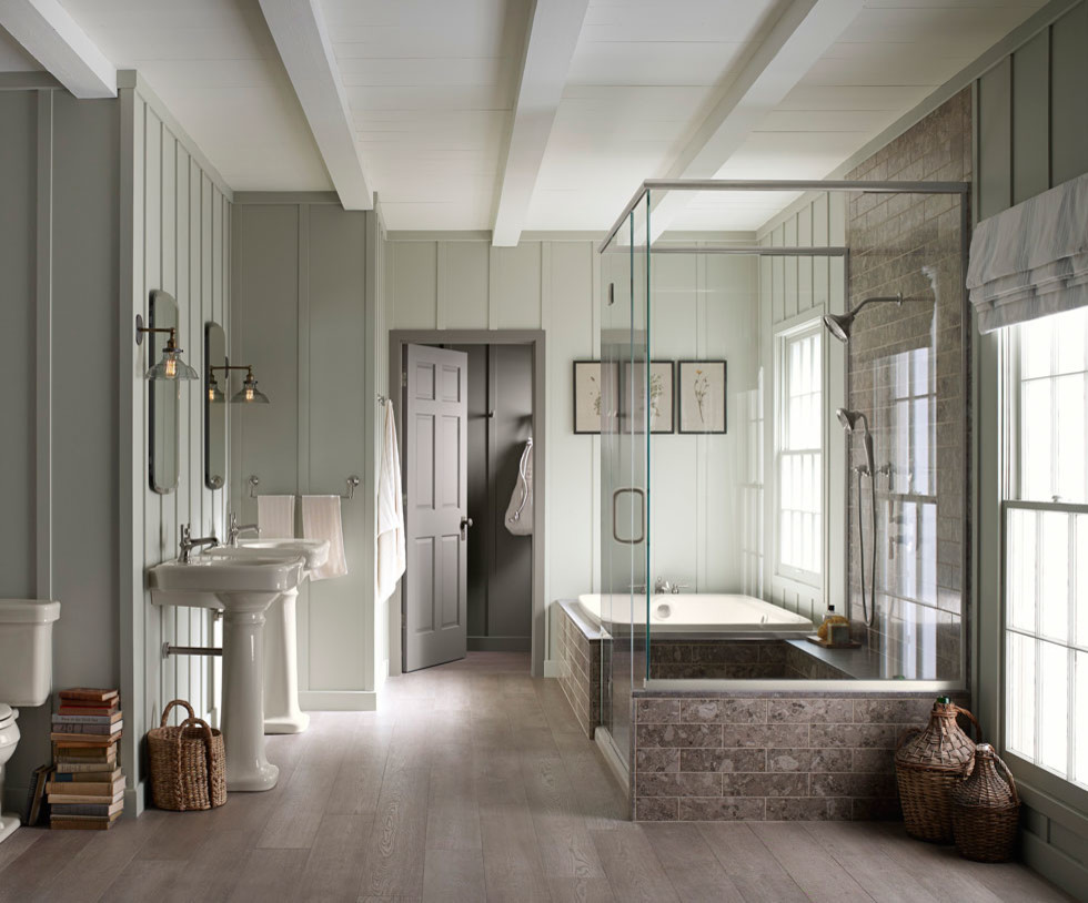 Inspiration for a medium sized traditional bathroom in Other with a built-in bath, a built-in shower, stone tiles, green walls, light hardwood flooring, a pedestal sink, beige floors and a hinged door.