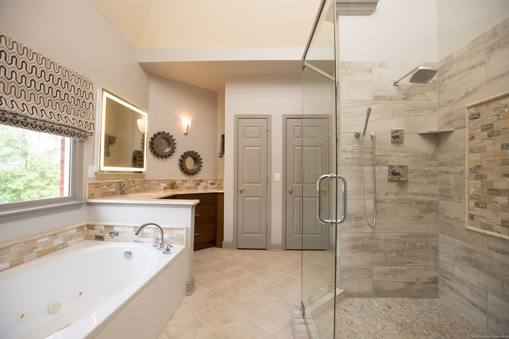 Inspiration for a large contemporary ensuite bathroom in Atlanta with a submerged sink, flat-panel cabinets, medium wood cabinets, engineered stone worktops, a built-in bath, a corner shower, beige tiles, stone tiles, beige walls and porcelain flooring.