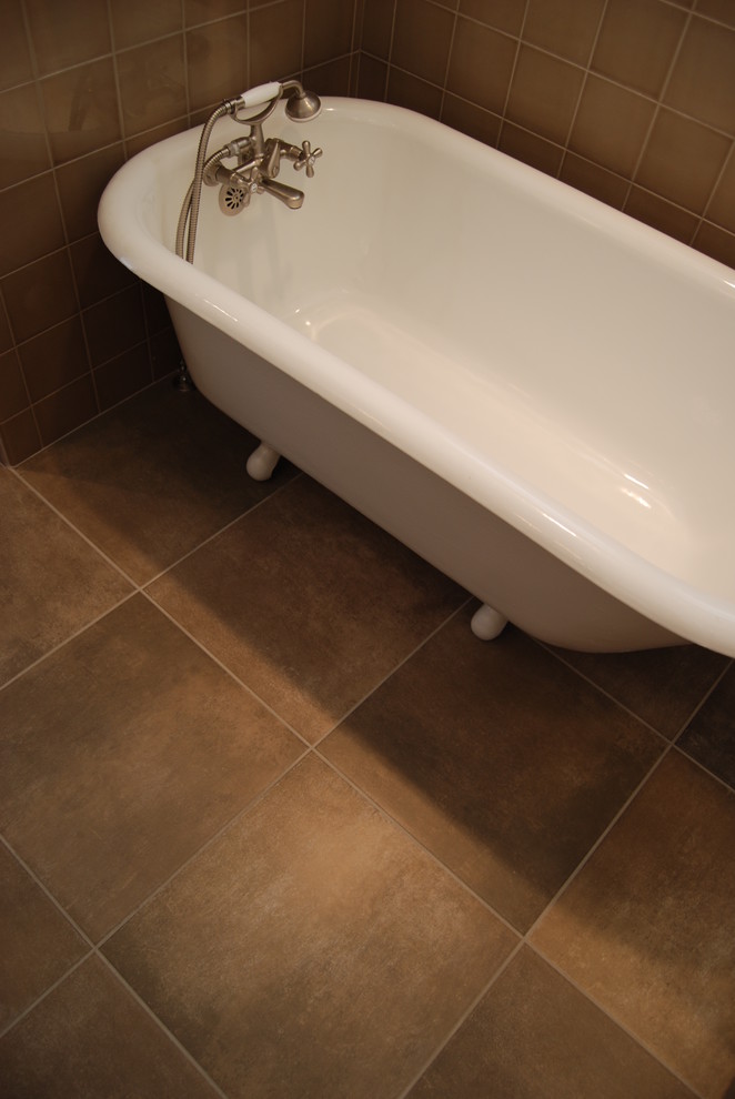 Inspiration for a mid-sized timeless master brown tile and porcelain tile porcelain tile claw-foot bathtub remodel in Seattle