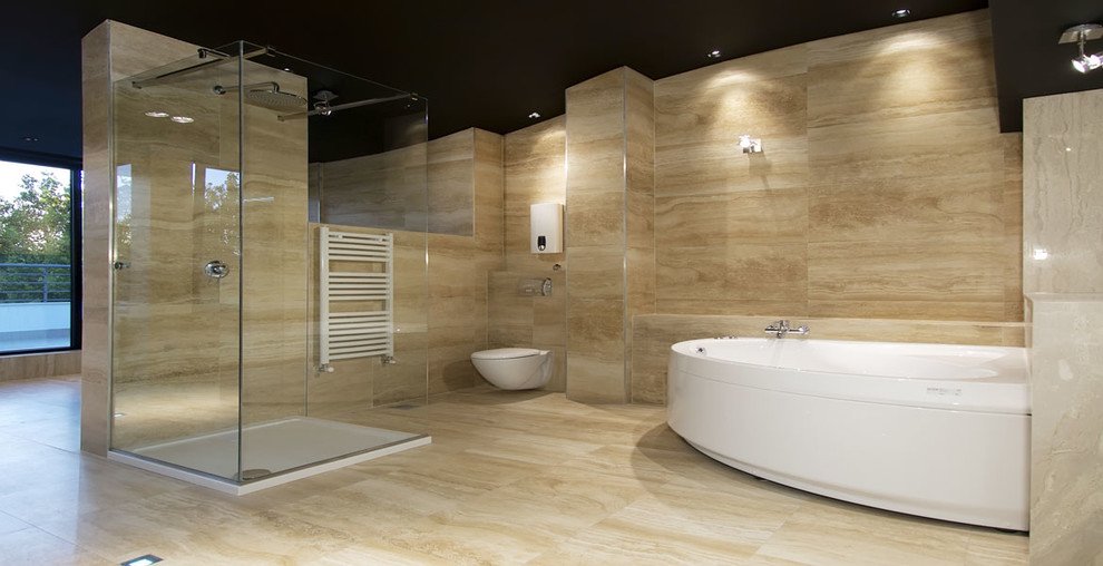 Photo of a large contemporary ensuite bathroom in Los Angeles with a corner bath, a walk-in shower, beige walls, marble flooring, a wall mounted toilet, beige tiles and marble tiles.