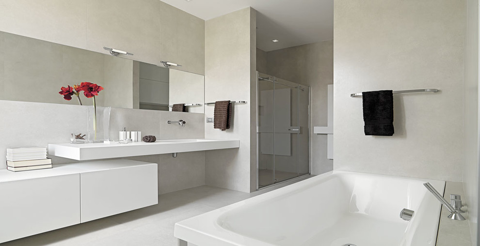 This is an example of a medium sized modern ensuite bathroom in Los Angeles with open cabinets, white cabinets, an alcove shower, beige walls, an integrated sink, engineered stone worktops and a freestanding bath.