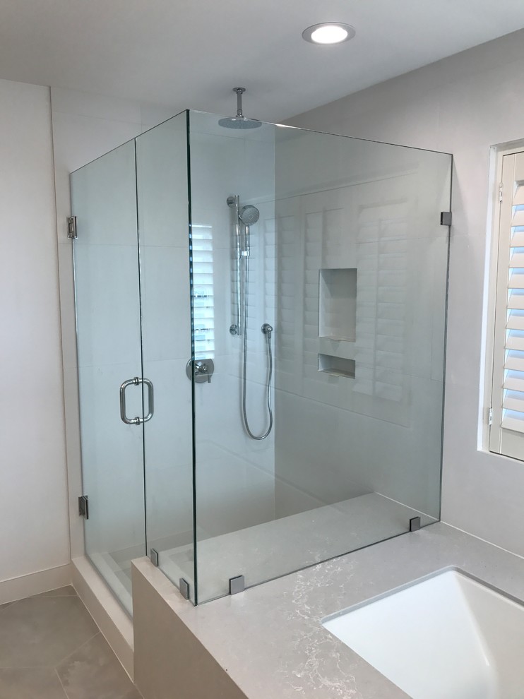 This is an example of a large ensuite bathroom in Los Angeles with shaker cabinets, white cabinets, a submerged bath, a corner shower, a one-piece toilet, white tiles, porcelain tiles, white walls, porcelain flooring, a submerged sink, engineered stone worktops, grey floors and a hinged door.