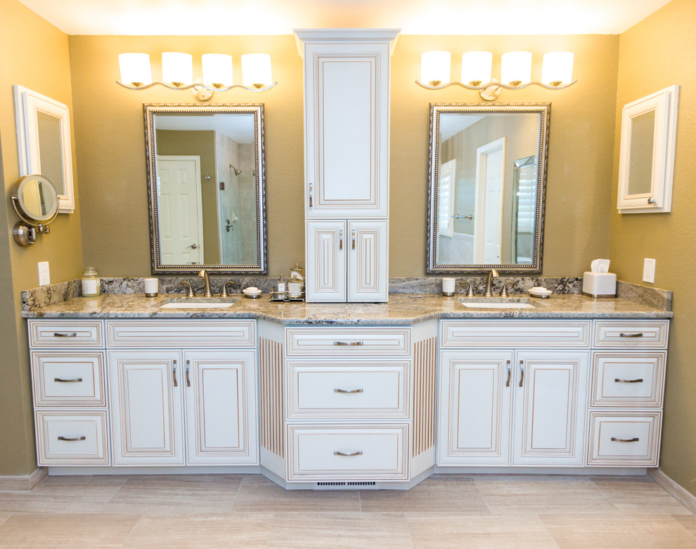 Example of a large classic master beige tile and porcelain tile porcelain tile bathroom design in Denver with an undermount sink, raised-panel cabinets, white cabinets, granite countertops, a one-piece toilet and beige walls