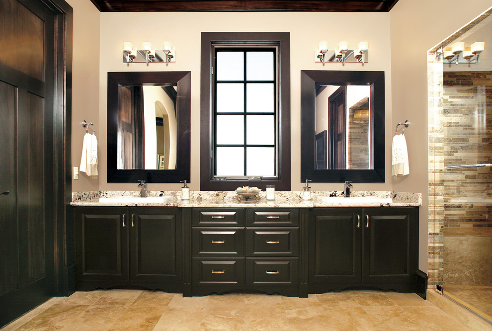 Traditional bathroom in Other with raised-panel cabinets and dark wood cabinets.