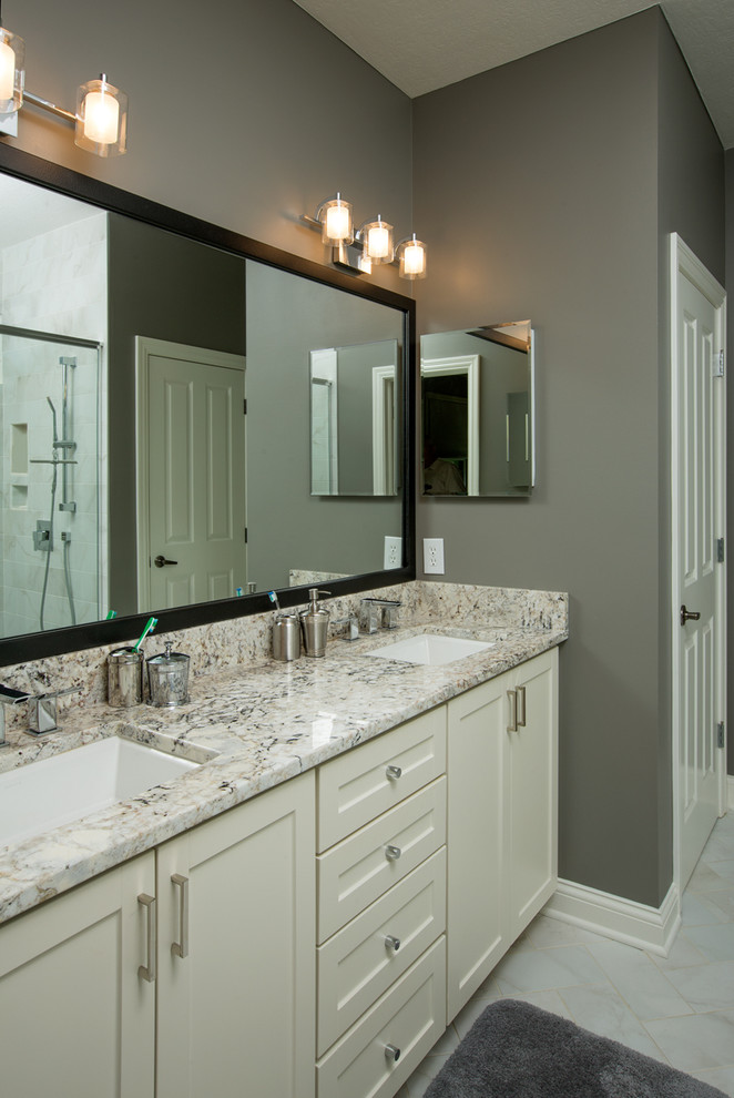 Medium sized contemporary shower room bathroom in Columbus with shaker cabinets, white cabinets, an alcove bath, a shower/bath combination, a two-piece toilet, white tiles, ceramic tiles, grey walls, marble flooring, a submerged sink and granite worktops.