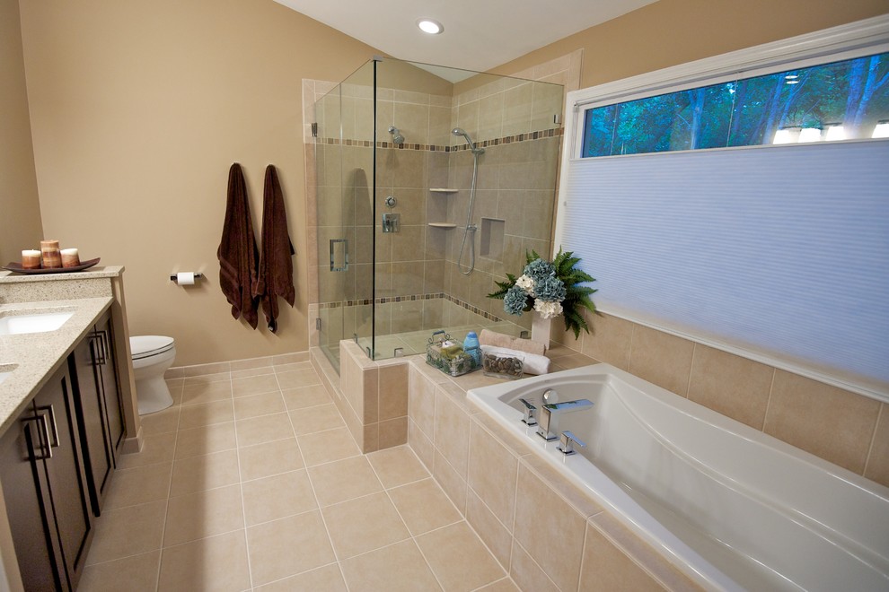 This is an example of a medium sized classic shower room bathroom in DC Metro with recessed-panel cabinets, dark wood cabinets, a built-in bath, a corner shower, a two-piece toilet, beige tiles, ceramic tiles, beige walls, ceramic flooring, a submerged sink, engineered stone worktops, beige floors and a hinged door.