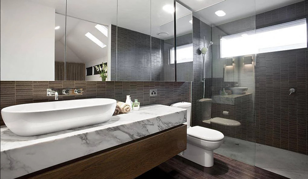 Photo of a medium sized contemporary ensuite bathroom in San Diego with flat-panel cabinets, medium wood cabinets, a built-in shower, a one-piece toilet, dark hardwood flooring, a vessel sink, granite worktops and an open shower.