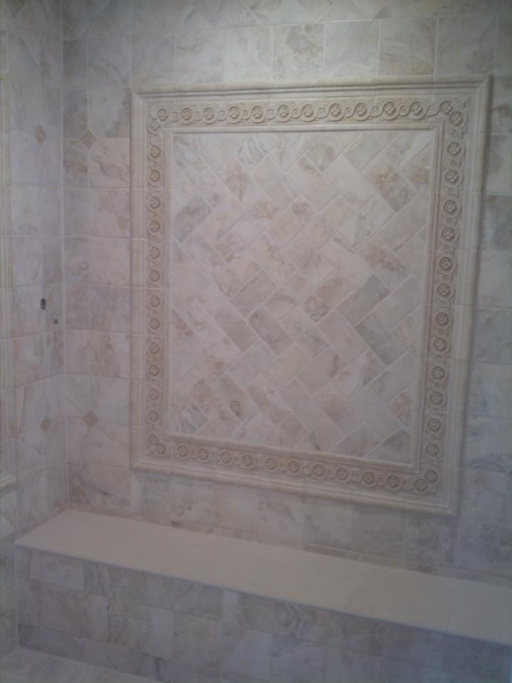 Example of a beige tile corner shower design in New York
