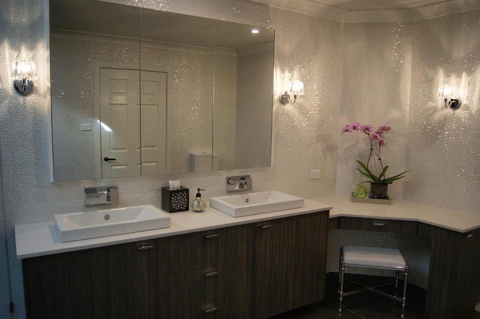 Photo of a medium sized contemporary bathroom in Sydney with a built-in sink, flat-panel cabinets, medium wood cabinets, engineered stone worktops, a walk-in shower, a one-piece toilet, white tiles, porcelain tiles, white walls and porcelain flooring.