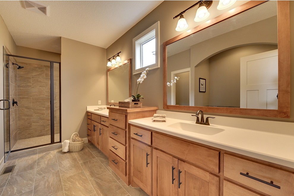 Inspiration for a mid-sized transitional master porcelain tile and brown tile porcelain tile bathroom remodel in Minneapolis with an integrated sink, shaker cabinets, medium tone wood cabinets, marble countertops, a one-piece toilet and beige walls