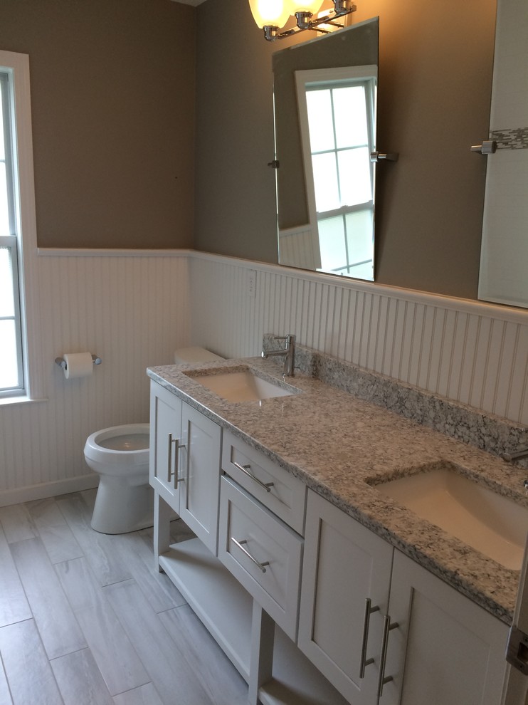 Inspiration for a coastal kids' white tile and subway tile ceramic tile bathroom remodel in New York with shaker cabinets, white cabinets, a one-piece toilet, gray walls, a drop-in sink and granite countertops