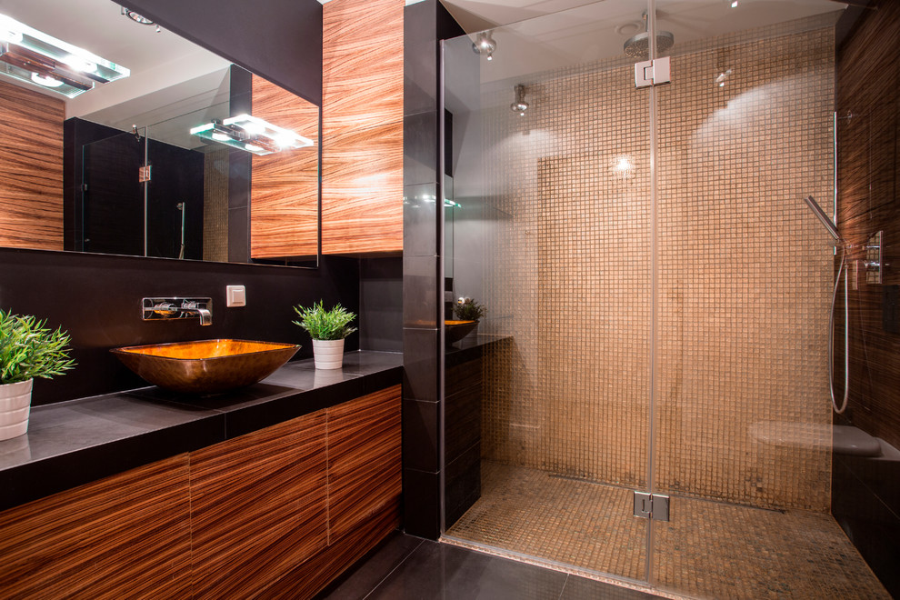 Réalisation d'une grande salle de bain design en bois brun avec un placard à porte plane, un plan de toilette en stéatite, un mur noir, un sol en carrelage de céramique et une vasque.