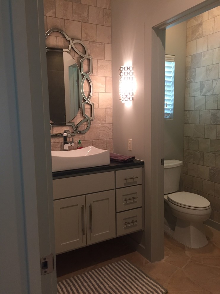 This is an example of a classic bathroom in Austin with a vessel sink and a one-piece toilet.