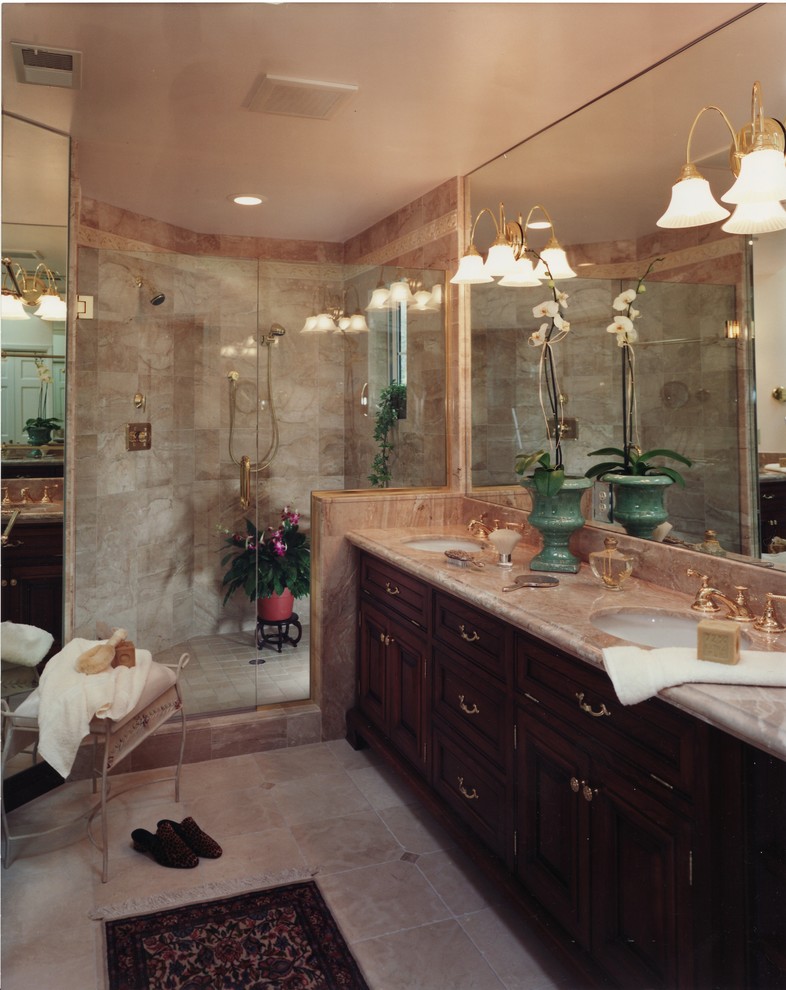 Photo of a large traditional ensuite bathroom in Denver with a submerged sink, raised-panel cabinets, dark wood cabinets, marble worktops, a double shower, multi-coloured tiles, stone tiles, beige walls and marble flooring.