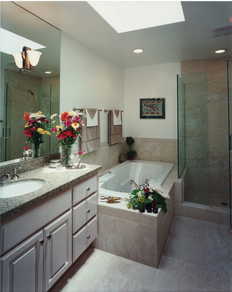 Bathroom - large contemporary master multicolored tile and stone tile travertine floor bathroom idea in Denver with an undermount sink, raised-panel cabinets, light wood cabinets, granite countertops and beige walls