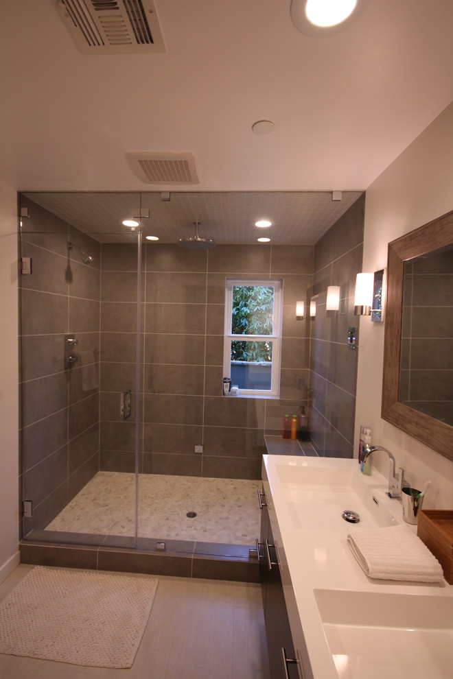 Trendy gray tile and porcelain tile sauna photo in Los Angeles with an integrated sink, flat-panel cabinets, dark wood cabinets, quartz countertops and a one-piece toilet
