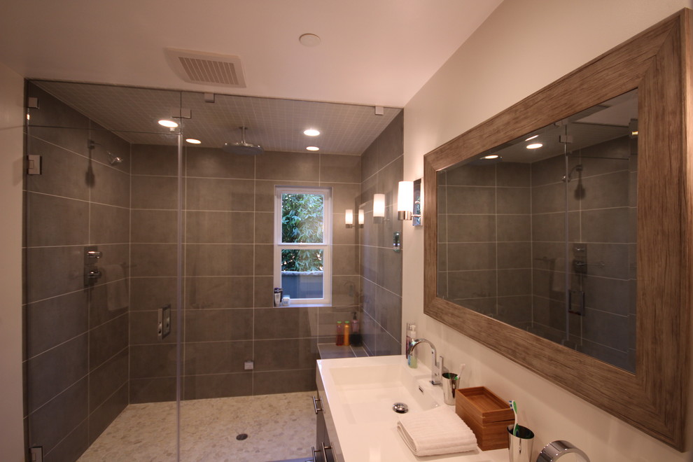 Example of a trendy gray tile and porcelain tile sauna design in Los Angeles with an integrated sink, flat-panel cabinets, dark wood cabinets, quartz countertops and a one-piece toilet