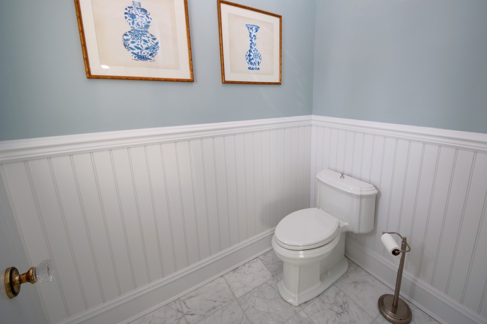 Large traditional ensuite bathroom in New York with beaded cabinets, white cabinets, an alcove bath, an alcove shower, a two-piece toilet, grey tiles, stone tiles, blue walls, marble flooring, a submerged sink, marble worktops, blue floors and a hinged door.
