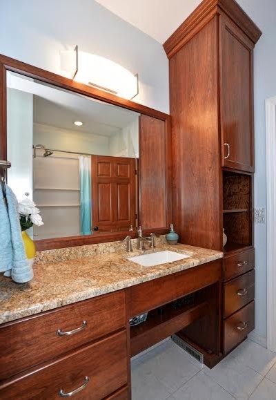 Inspiration for a mid-sized timeless master medium tone wood floor doorless shower remodel in Other with recessed-panel cabinets, medium tone wood cabinets, a two-piece toilet, green walls, a drop-in sink and granite countertops
