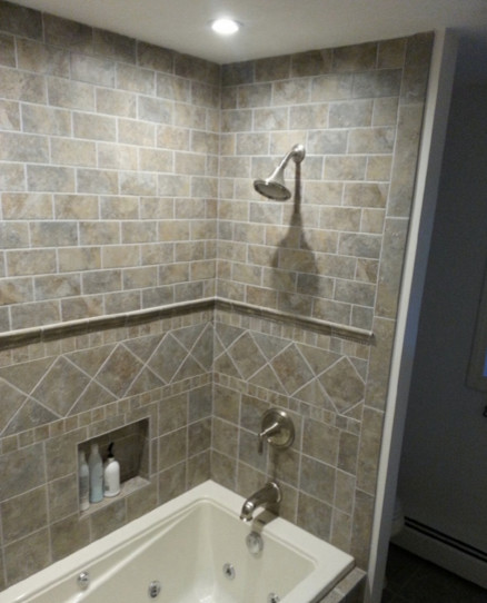 Photo of a medium sized contemporary ensuite bathroom in Manchester with an alcove bath, a shower/bath combination, beige tiles, brown tiles, grey tiles and ceramic tiles.