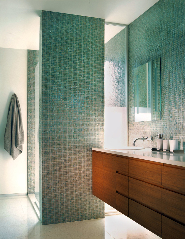 Modern inredning av ett stort en-suite badrum, med släta luckor, skåp i mellenmörkt trä, en dusch i en alkov, en toalettstol med hel cisternkåpa, blå kakel, mosaik, vita väggar, ett nedsänkt handfat och bänkskiva i kvarts