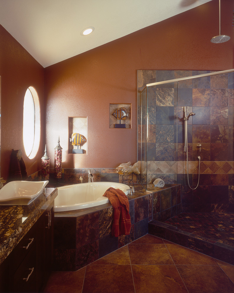 Photo of a traditional bathroom in San Diego with a vessel sink, shaker cabinets, dark wood cabinets, granite worktops, a built-in bath, a corner shower, brown tiles and stone tiles.