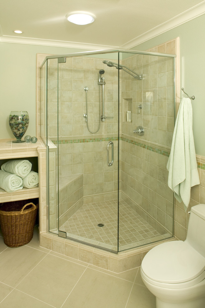 Corner shower - traditional beige tile and ceramic tile corner shower idea in San Diego with tile countertops