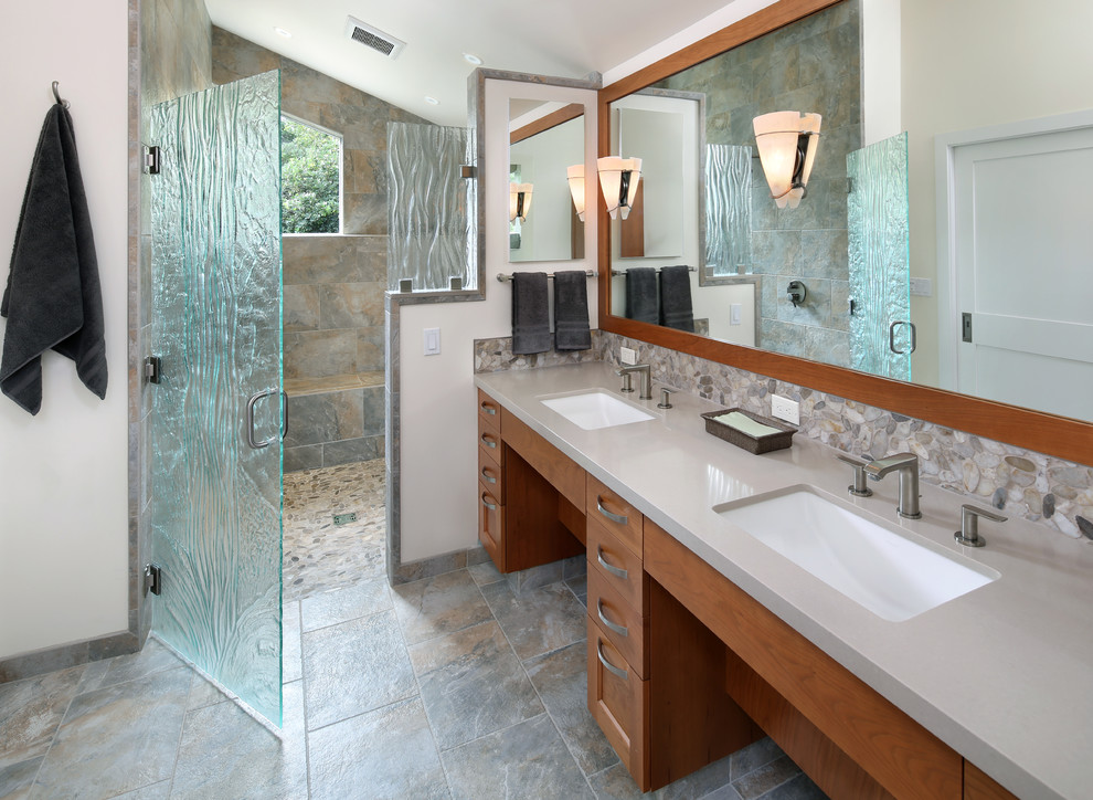 Photo of a contemporary bathroom in San Francisco with a submerged sink, flat-panel cabinets, medium wood cabinets, multi-coloured tiles, pebble tiles and white walls.