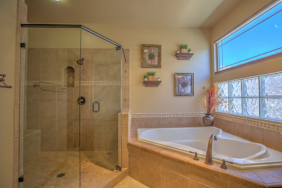 Großes Klassisches Badezimmer En Suite mit profilierten Schrankfronten, hellbraunen Holzschränken, Whirlpool, Eckdusche, beigen Fliesen, Keramikfliesen, beiger Wandfarbe, Keramikboden, integriertem Waschbecken und Laminat-Waschtisch in Albuquerque