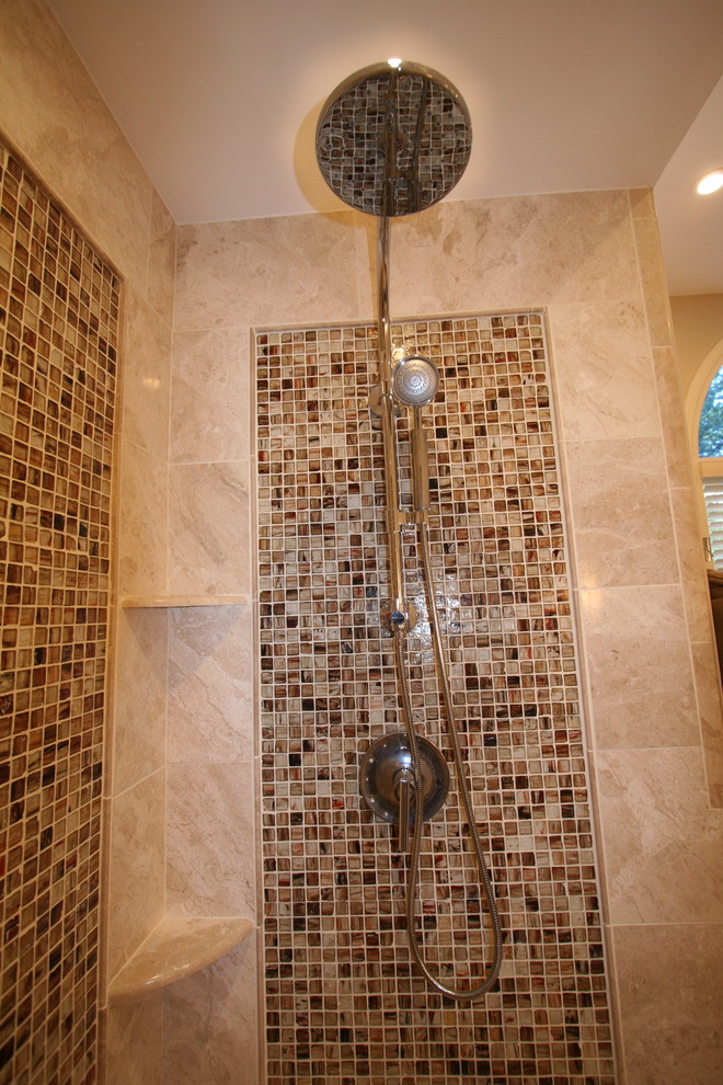 Photo of a large traditional ensuite bathroom in New York with an alcove shower, beige tiles, beige walls, glass tiles and marble flooring.