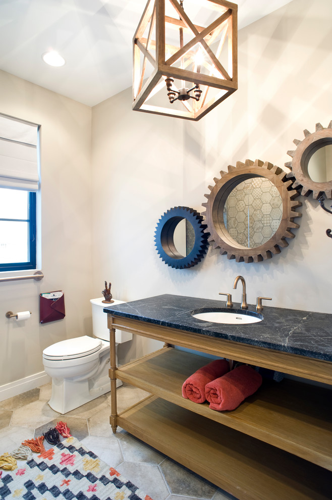 Bild på ett funkis badrum med dusch, med öppna hyllor, bruna skåp, en toalettstol med separat cisternkåpa, beige väggar, klinkergolv i keramik, ett undermonterad handfat, bänkskiva i täljsten och flerfärgat golv