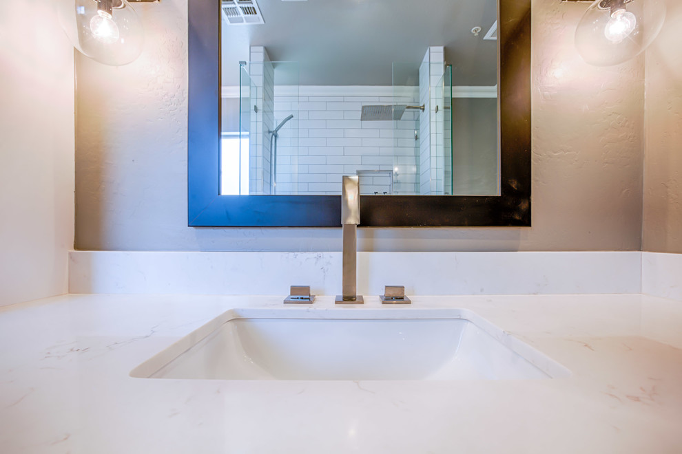 Example of a large minimalist master white tile and subway tile porcelain tile and gray floor bathroom design in Phoenix with flat-panel cabinets, white cabinets, a one-piece toilet, gray walls, an undermount sink and quartzite countertops