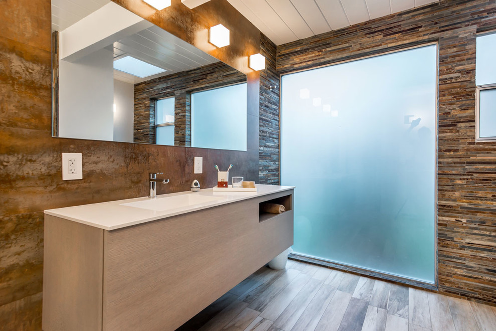 Photo of a contemporary bathroom in San Francisco with flat-panel cabinets, light wood cabinets, brown tiles, matchstick tiles and white worktops.